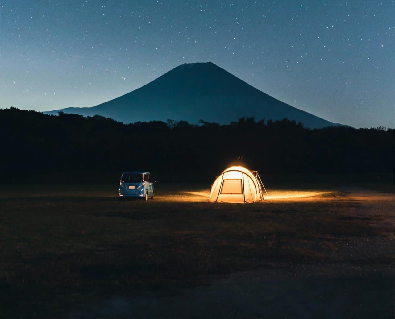 Tent pitched near a lake with mountains in Japan